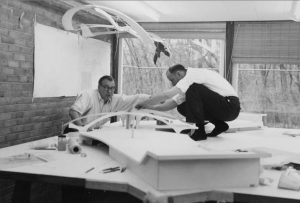 Eeero Saarinen and Kevin Roche with model of TWA, 1957